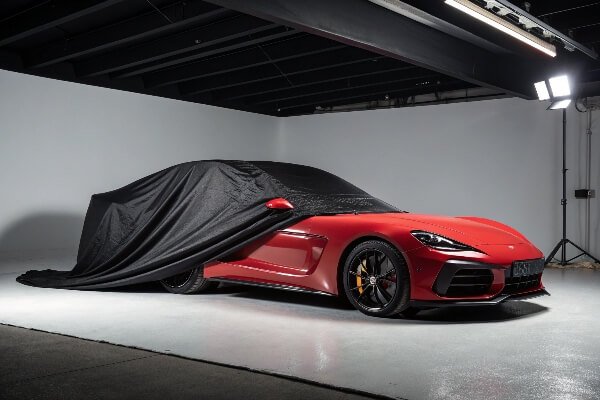 Custom-fit car cover providing a perfect fit A sleek, custom-fit car cover perfectly outlining the shape of a sports car