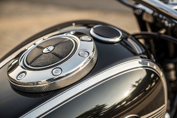 A close-up shot of a soft, anti-static inner liner of a car cover gently resting on a chrome gas cap