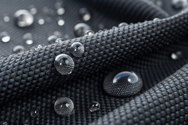 IPX4 waterproof fabric technology for motorcycle covers A close-up shot showing water beading on a waterproof motorcycle cover fabric