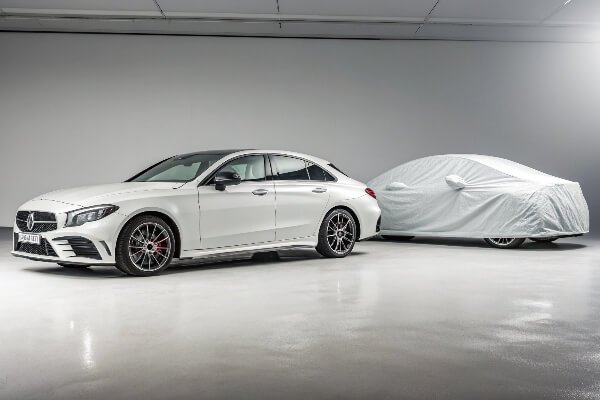 Custom vs. Universal Car Covers A custom-fit car cover next to a universal-fit car cover on similar cars
